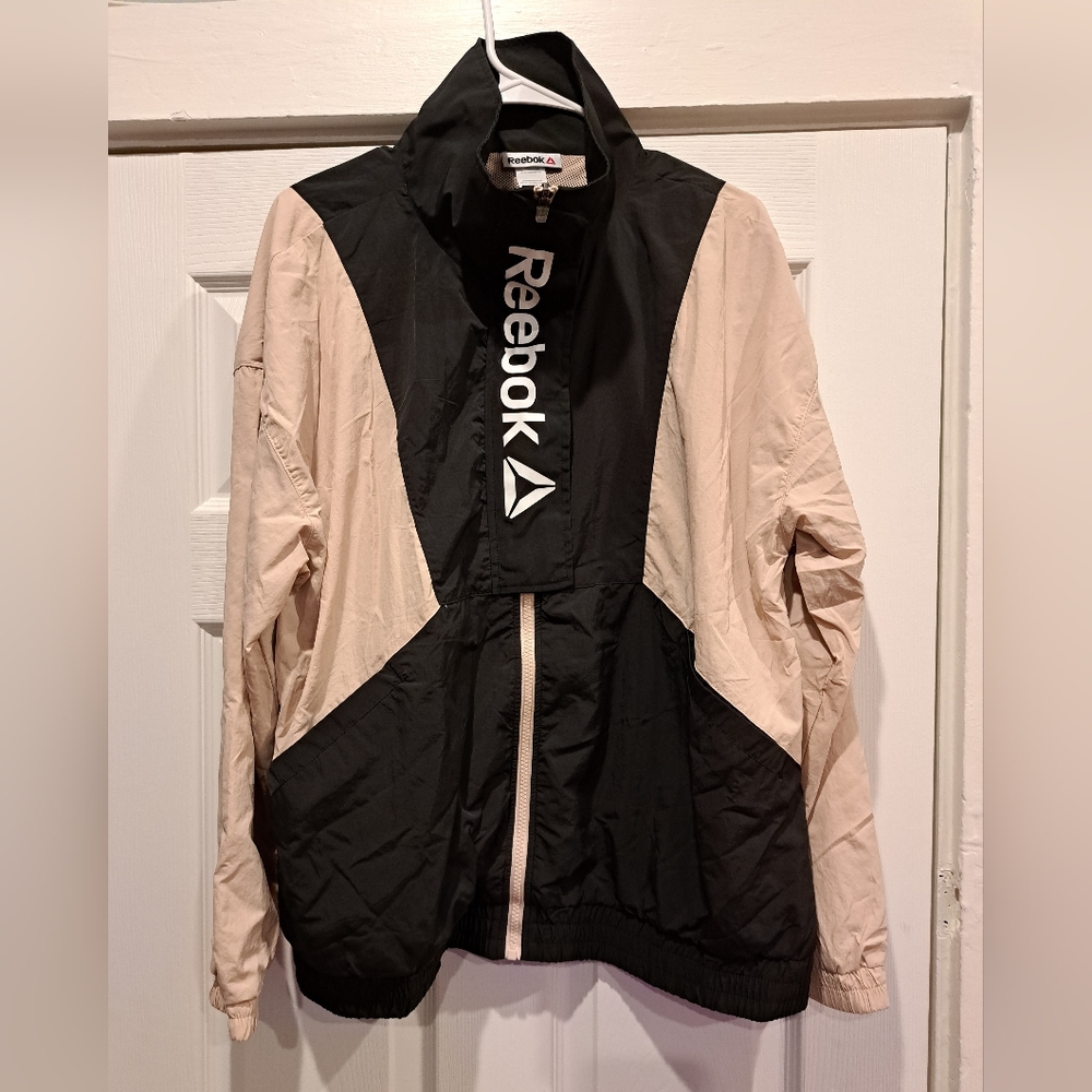 Tan and black Reebok windbreaker zip jacket.